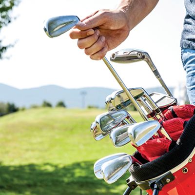 Golfer Pulling Out a Golf Club From Red Golf Bag
